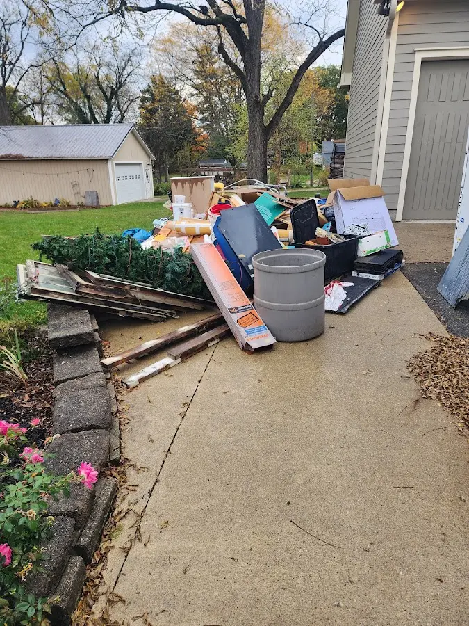 Dumpster being loaded with debris for Roofing Dumpster Rental in Gypsum